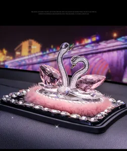 Crystal swan car ornament with pink rhinestones and fluffy base for auto decor.