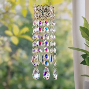 Close-up detail of colorful crystal suncatcher hanging in a bright garden for home decor