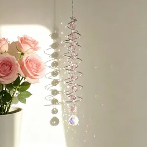 Close-up of spiral crystal wind chime suncatcher with pink beads and rainbow reflections