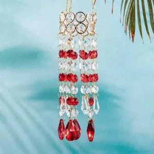 Close-up of a sparkling crystal suncatcher with red and clear faceted beads for garden decor