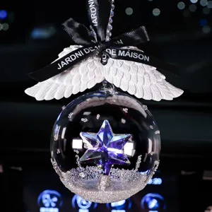 Elegant car crystal hanging ornament with purple star and white angel wings detail.