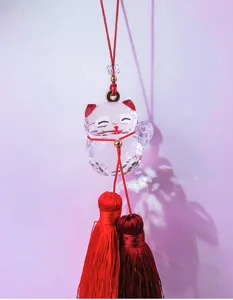 Crystal Maneki-neko lucky cat car hanging ornament with red tassels and rainbow reflections