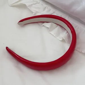 Close-up of vibrant red leather padded headband with high top French design style