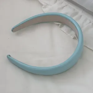 Detailed view of the light blue glossy leather sponge headband with padded design