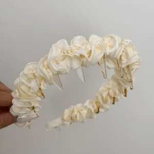 Elegant cream pleated satin headband with clear comb teeth for versatile hair styling