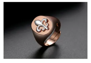 Close-up of a vintage two-tone men's signet ring with a silver Fleur-de-lis on rose gold
