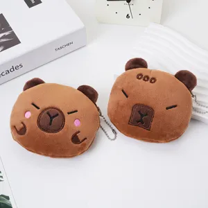 Detailed macro view of two cute cartoon capybara plush coin purses with soft fur texture