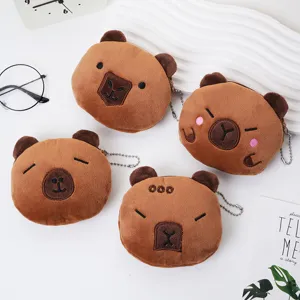 Detailed view of four cute brown capybara plush coin purses with varied facial expressions