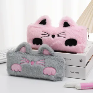 Detail of cute cat-shaped plush pencil cases in pink and grey faux rabbit fur