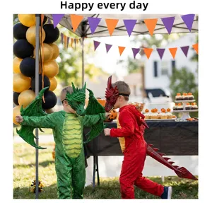 Detailed shot of kids in green and red dragon costumes at an outdoor Halloween party event