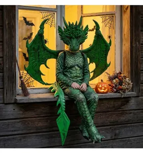 Realistic green dragon costume for kids with wings and mask on Halloween window sill.