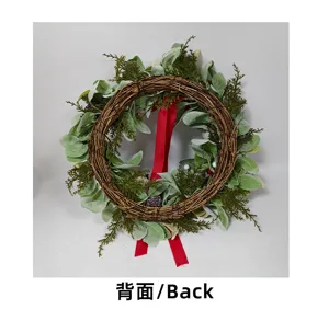 Rear view of a handcrafted Christmas greenery wreath showing vine base and red ribbon