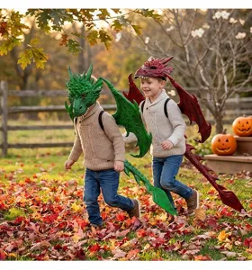 Detailed view of children wearing green and red dragon costume sets in autumn garden