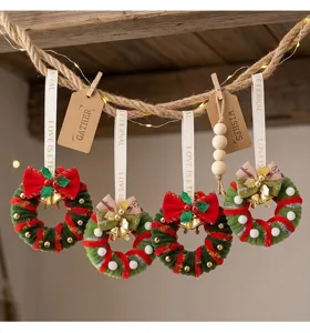 Detailed view of mini Christmas wreaths hanging with rustic rope and wooden clips