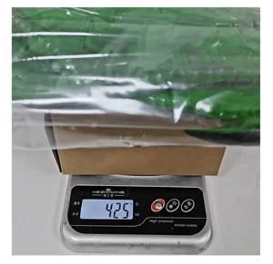 Detail shot showing the weight measurement of a green children's dragon costume set at 425g
