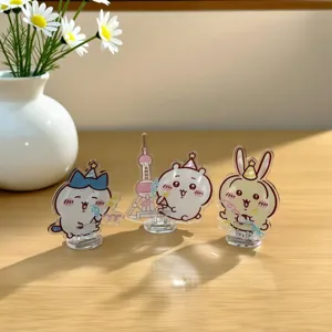 Detailed close-up view of transparent acrylic cartoon character standees on a wooden desk