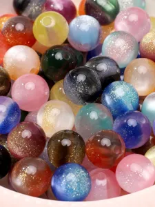 Macro view of colorful 8-10mm resin beads with fine glitter and gradient gold powder