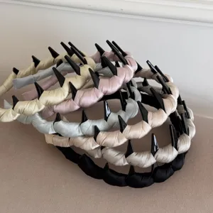Detailed view of satin thickened wave tooth headbands in assorted pastel colors for hair