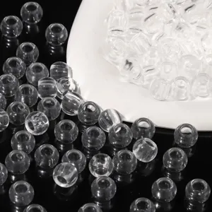 Detailed view of clear transparent acrylic beads with large holes for DIY craft jewelry
