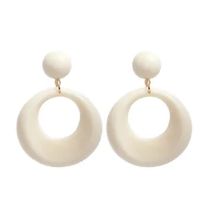 Close-up view of French retro cream geometric round earrings with sphere stud