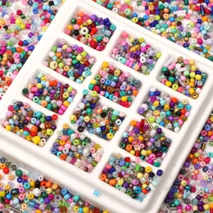 Macro shot of 2-4mm colorful mixed glass seed beads and bugle beads in a white sorting tray