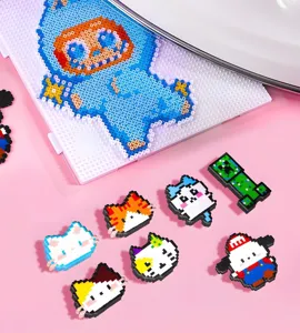 Close-up of colorful DIY 2.6mm fuse bead pixel art figures on pink background