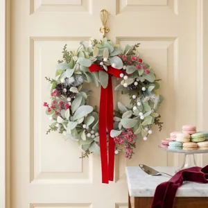 Festive Christmas wreath with lamb's ear leaves and a long red velvet ribbon bow.