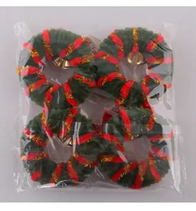 Set of four mini green Christmas wreaths with red trim and gold bells in clear bag