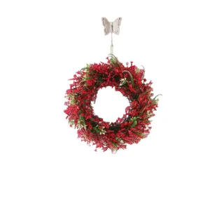 Festive red Christmas wreath with green foliage for elegant door or window decoration