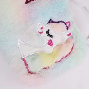 Close-up of fluffy rainbow unicorn plush pencil case with cute embroidery details