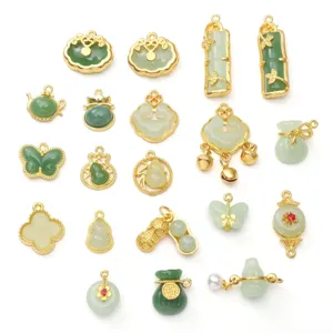 Macro view of assorted imitation jade and gold alloy charms for DIY jewelry making