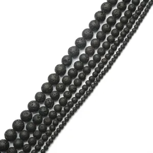 Close-up of black porous lava stone round beads in various sizes for DIY jewelry