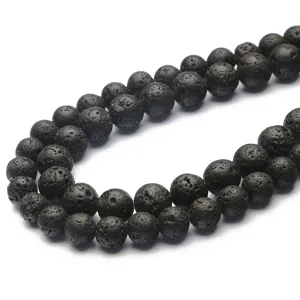 Detailed macro view of 4-12mm black volcanic lava stone beads for DIY jewelry making