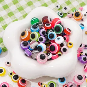 Detailed macro shot of vibrant rainbow striped resin evil eye beads for DIY jewelry making