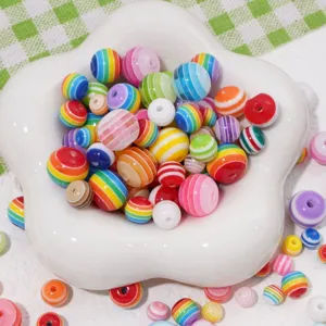 Macro view of various colorful rainbow striped resin beads for DIY jewelry making crafts