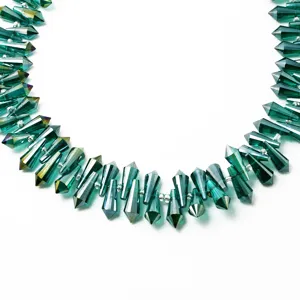 Detailed close-up of 6x15mm teal faceted glass teardrop beads for DIY jewelry making