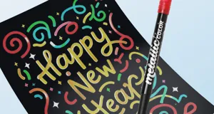 Detailed view of metallic marker pen showing vibrant shiny effect on black card