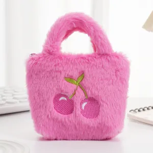 Detailopname van een roze pluche handtas met schattig kersengeborduur op zacht imitatiebont.