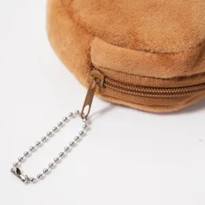 Gros plan d'une trousse capybara en peluche marron avec fermeture éclair et chaîne à billes