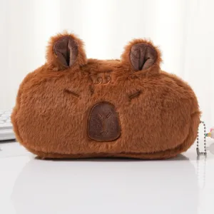 Close-up detail showing the cute brown capybara plush pencil case with a soft texture.
