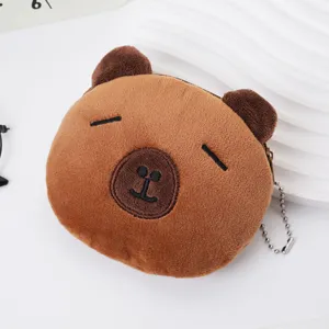 Close-up of cute brown plush capybara coin purse with embroidered facial details