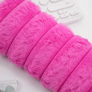 Detalle macro de la suave textura fucsia de pelo de conejo sintético de un estuche de felpa