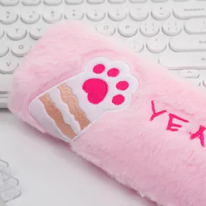 Detailed view of soft pink plush pencil case featuring a cute embroidered cat paw design