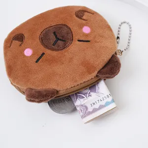 Detailed view of a cute plush capybara coin purse showing scale with coins and cash.