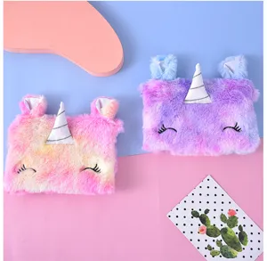 Gros plan sur de mignons porte-monnaie licorne en peluche aux dégradés rose et violet