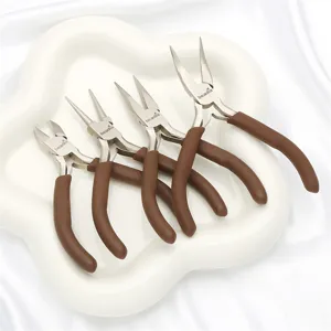 Close-up of four professional mini DIY jewelry pliers with coffee brown handles on white tray.
