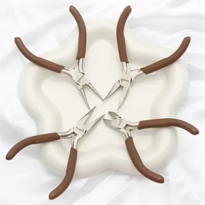 Set of four brown mini jewelry pliers for DIY craft and beading on a white tray