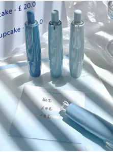 Close-up of aesthetic gradient correction tape pens in a soft blue-toned desk setting