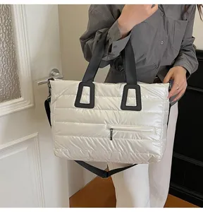 Large capacity quilted puffer tote bag for women shown in a lifestyle shoulder carry pose