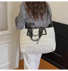 Large white quilted puffer tote bag styled as a crossbody on model back view indoors